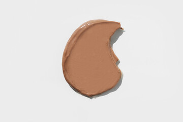 Top view of the cosmetic brown cream on white background, different swatches. Pastel colors. Good as cosmetics mockup