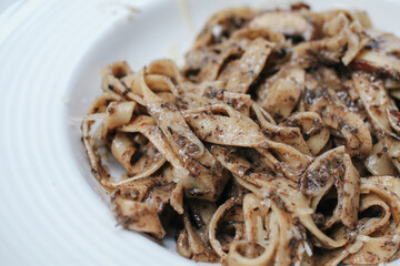 Spaghetti with truffle mushrooms and cream sauce  on wooden table in restaurant. A delicious italian fusion pasta