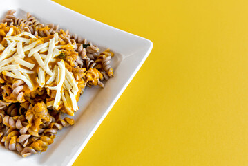Fusilli pasta with pumpkin sauce and colonial cheese, homemade food.