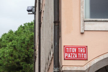 Bilingual street sign indicating Titov Trg in Slovenian & Piazza Tito in Italian meaning Tito Street street obeying the slovenian biligualism minority laws Koper. Tito was communist yugoslav leader
