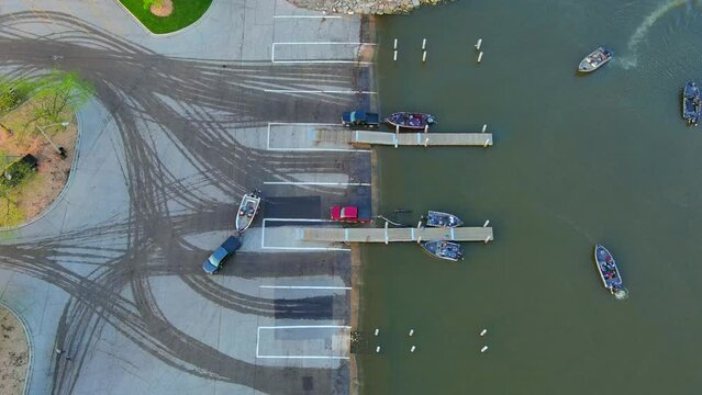 Many fishing boats being launched in Springtime on a Saturday morning, aerial time lapse.
