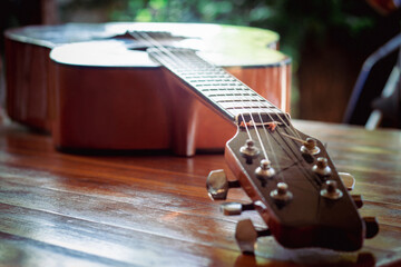 Classical guitar on the table with bokeh background, depth of field