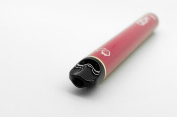 Modern electronic cigarette on a white background. Fashionable smoking device. E-cigarette for vaping. Trendy vape pod. Selective focus