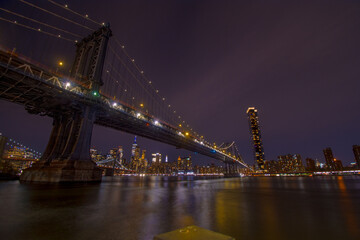 Brooklyn Bridge at dusk viewed from the Brooklyn Bridge Park in New York City. - obrazy, fototapety, plakaty