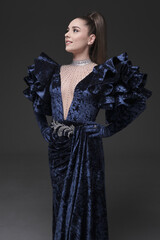 beautiful girl in an evening dress in the studio
