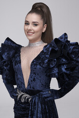 beautiful girl in an evening dress in the studio