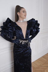 beautiful girl in an evening dress in the studio