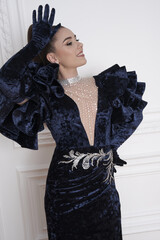 beautiful girl in an evening dress in the studio
