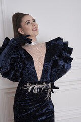 beautiful girl in an evening dress in the studio