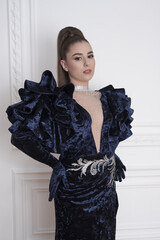 beautiful girl in an evening dress in the studio