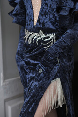 a young girl in an evening dress at the window leaned on the door