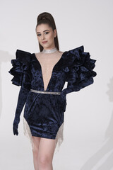 beautiful girl in an evening dress in the studio