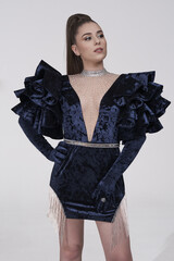 beautiful girl in an evening dress in the studio