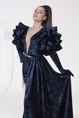 beautiful girl in an evening dress in the studio