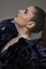 beautiful girl in an evening dress in the studio