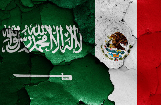 flags of Saudi Arabia and Mexico painted on cracked wall
