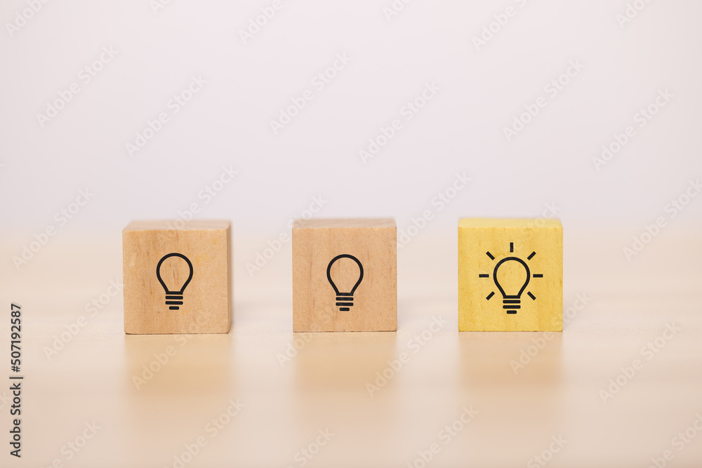 Poster wooden blocks with light bulb in the row. concept for creative and design solution.