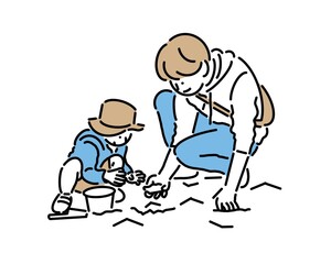砂場で一緒に遊ぶお父さんと子供