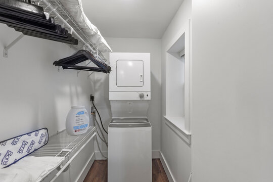 Stacked Washer And Dryer In Laundry Room Of Apartment