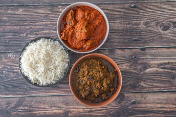 Bowl of rice served with Ofada and Pepper tomato stew
