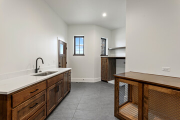 Laundry room with tiles and wood counter top with sink