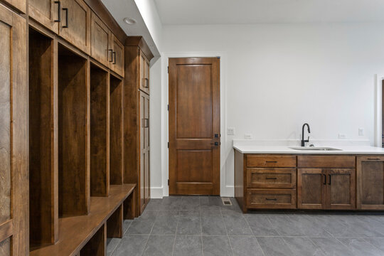 Empty Mudroom With Sink And Wooden Built-ins