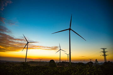 Fototapeta na wymiar Wind turbines power plant at sunset are alternative electricity, the concept of sustainable resources. Green energy concept to reduce global warming and climate change and pollution