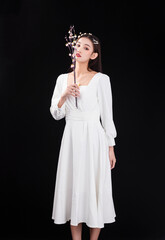 A young woman in a white dress and veil