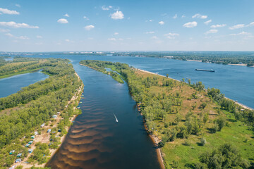 Obraz premium Aerial landscape view on Volga river with islands and green forest. Picturesque panoramic view from the height on the touristic part of the Volga river near Samara city at summer sunny day.