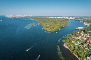 Aerial landscape view on Volga river with islands and green forest. Picturesque panoramic view from the height on the touristic part of the Volga river near Samara city at summer sunny day.
