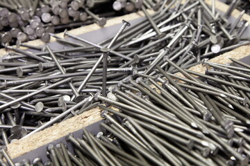 A lot of new common nails in wooden box. Construction fasteners.