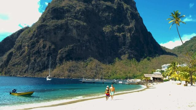 St Lucia Caribbean, couple men and women on vacation,Huge pitons drone view at Saint Lucia sugar beach St Lucia mountains at the beach with clear ocean