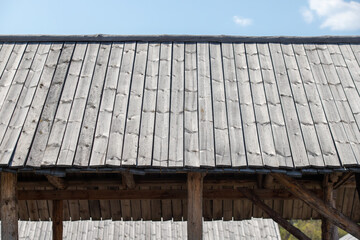 Old wooden roof against the sky.