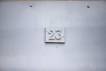 House number figures old wall background.