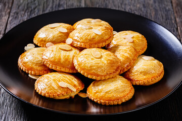 almond cookies on black plate, top view