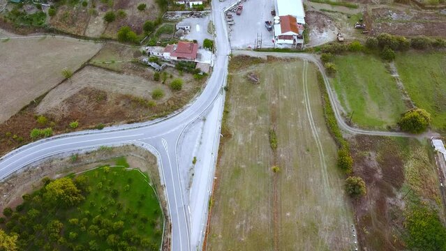 Aerial view of small village and crop fields at Autumn