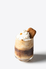 Cookies layered coffee with whipped cream  and decorated with biscuits on the  white isolated background.