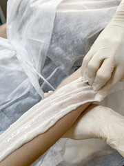 hand depilation. epilation with sugar wax. sugaring, beauty salon. body hair removal paste. smooth skin