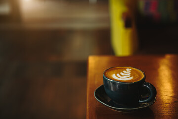coffee latte art in coffee shop in vintage color tone.