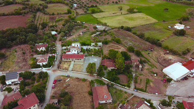 Aerial view of small village and crop fields at Autumn