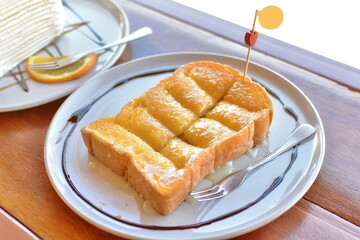 Toasted bread topped with butter and milk.
