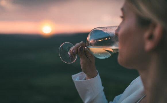 Close up of woman drinking white wine