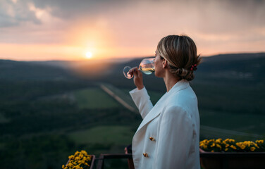 Side view of woman drinking white wine