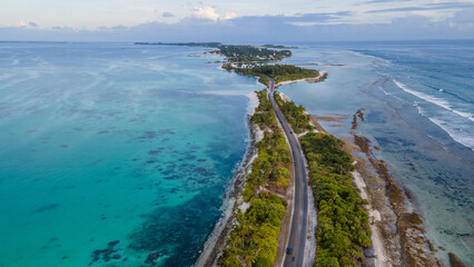 Aerial view of tropical beach landscape and local road at addu city, the southernmost atoll of...