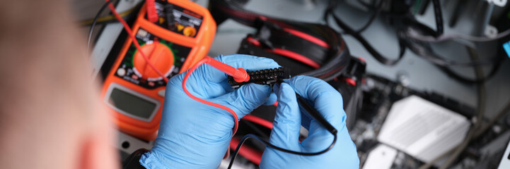 Man working with multimeter for computer repair - obrazy, fototapety, plakaty