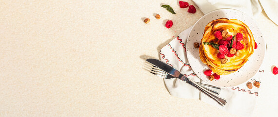 Classic homemade American pancakes with frozen raspberries, hazelnut and mint. Healthy breakfast