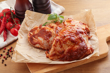 Marinated chicken leg in tomato sauce