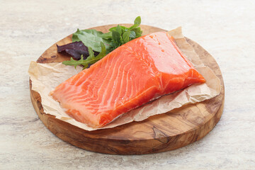 Raw salmon fillet over board