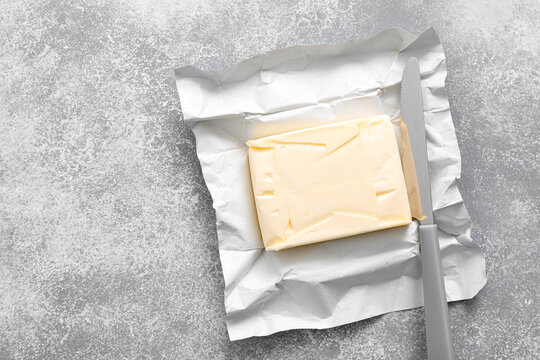 Block of butter with butter knife in a open pack