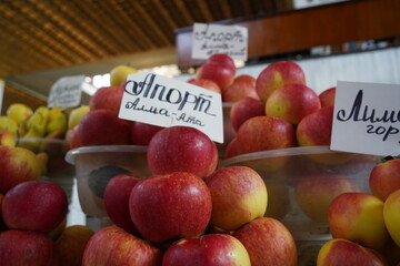 Almaty, Kazakhstan - 03.25.2022 : Sale of large apples. The inscription on the plate is Aport. A valuable variety of Almaty apples.